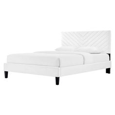 a white bed with black legs and headboard