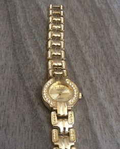 "Oleg cassini women's gold watch having a round gold dial with index hours all on a gold stainless steel linked band. this is a rare find a vintage watch still in new condition. this item will arrive in a velvet watch pouch perfect for gifting or storage of this item. measurements: bezel(case 7/8\" in diameter), dial 1/2\" in diameter, band width 1/2\" and fits a standard 7 1/2\" wrist perfectly. if a smaller fit is needed, we offer free sizing of this item, just contact us via of message's prio Gold Analog Diamond Watch With Round Dial, Gold Diamond Analog Watch With Round Dial, Gold Analog Diamond Watch, Timeless Gold Diamond Watch, Gold Metal Watches For Anniversary, Gold Watches Women, Oleg Cassini, Fort Lauderdale, Vintage Watches