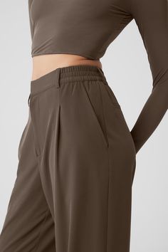 These trousers have “closet staple” written all over them. They have a high-rise waistband (flat in the front and stretchy in the back), classic details (belt loops and pleats) and a relaxed, wide-leg fit. Plus, they’re made from a lightweight, slightly stretchy fabric that looks sleek and feels totally comfortable. You'll go straight from work to your weekend plans with just a change of shoes. Womens Onesie, Tank Top Bras, Weekend Plans, Womens Capris, Tank Top Long Sleeve, Back Women, Olive Tree, Alo Yoga, Bra Women