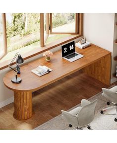 a computer desk with a laptop on it in front of a window and bookshelf