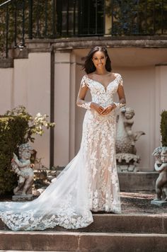 a woman in a wedding dress standing on steps