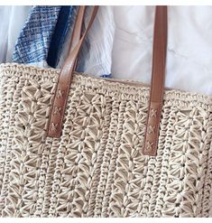 an image of a woven bag with leather handles