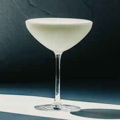 a white wine glass sitting on top of a table