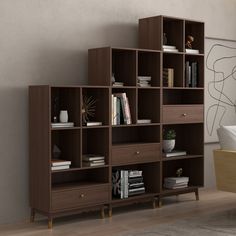 a room with a table, chairs and bookcases in front of the wall