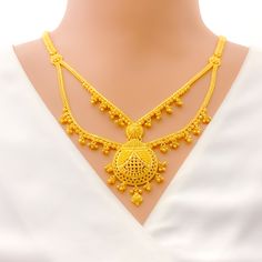 This 22k gold long necklace set features an ornamental tasseled drop design, perfect for adding elegance to any outfit. Weighing 53.9 grams, it showcases a yellow gold finish that enhances its intricate and eye-catching appearance. The set has a length of 24 inches with a 2.25-inch drop and includes adjustable 1.5-inch links for a comfortable fit. Secured with a hook lock, it combines style and practicality. The matching earrings, each 1.75 inches long, feature screw back posts for added security. Ideal for those who appreciate luxurious and sophisticated jewelry, this set brings a touch of opulence and tasseled charm to your collection. PRODUCT DETAILS Gold Purity(karat): 22k Gold Weight(grams): 53.9 Item Finish: Yellow Gold Set Length: 24" Drop Length: 2.25" Adjustable Links: 1.5" Links Elegant Yellow Gold Bridal Necklace With Latkans, Elegant Gold Temple Necklace With Latkans, Elegant 22k Gold Temple Necklace With Latkans, Elegant Yellow Gold Temple Necklace With Latkans, Gold Long Necklace Set, Long Necklace Set, Bridal Jewelry Necklace, Precious Stones Rings, Sophisticated Jewelry