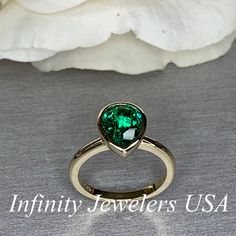 "The ring pictured is lab created emerald #7072 Rose Gold is available upon request as a custom order and is a final sale (non refundable, non returnable, non exchangeable). -Approximate total carat weight: approx. 2.10ctw diamond equivalent -Center Stone Size: 10x7mm - approx. 2.10ct diamond equivalent -Center Stone Shape: pear shape -Gem Type: lab created emerald -Stone Clarity: VS2 -Stone Color: Green -Moh's Scale: 8.5 hardness -Metal Type and Purity: 14k yellow gold -Setting: bezel set -Stoc Green Heart Cut Emerald Ring For Formal Occasions, Heart Cut Green Emerald Ring For Formal Occasions, Formal Green Heart Cut Emerald Ring, Classic Teardrop Emerald Jewelry, Classic Pear-shaped Emerald Jewelry, Yellow Gold Teardrop Emerald Ring For Anniversary, Green Solitaire Teardrop Jewelry, Green Teardrop Emerald Ring For May Birthstone, Heart Cut Emerald Green Jewelry