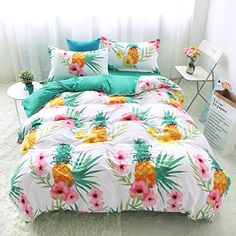 a bed with pineapples and flowers on it