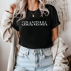 Custom Grandma T-shirt , Grandkids Name T-Shirt, Gift For Grannny T-shirt, Personalized Nana T-shirt,Mothers Day Gift,Best Grandmother Gift **Product Details** We exclusively utilize Bella Canvas and Gildan SoftStyle brands for our printing needs, renowned for their superior quality in the industry. *Bella Canvas - Available in unisex sizes - Weighing 4.2 oz. - Solid colors crafted from 100% Combed Cotton and Ring-Spun Cotton. - Athletic Heather composed of 90% Combed and Ring-Spun Cotton, 10% P Black Family Matching T-shirt With Name Print, Black T-shirt With Name Print For Family Matching, Black Short Sleeve Top With Name Print, Black Family Matching Tops With Text Print, Graphic Tee With Name Print Short Sleeve, Black Crew Neck T-shirt With Name Print, Mother's Day Crew Neck Shirt With Text Print, Mother's Day Short Sleeve Relaxed Fit T-shirt, Mother's Day Graphic Tee With Crew Neck