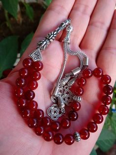 ✔️ This magnificent tasbih made with AA quality 8 mm carnelian agate beads. ✔️ It is a elegant and striking tesbih. ✔️ Natural Color ✔️ Natural Stone ✔️ Each order comes in a special box. ✔️ PLEASE CLICK THE LINK FOR ALL PRAYER BEADS MODELS https://www.etsy.com/shop/GoodJewelsofYazmasal Note: As a natural feature the stones beads may have some variations. SHIPPING: United States (Standart/DHL eCommerce/usps): 7-10 business days United States (Express/FedEx): 3-5 business days Canada (Express/Fed Spiritual Red Beads, Gems, And Cabochons For Gifts, Polished Beads For Gifts And Festivals, Traditional Red Round Beads, Gems, And Cabochons, Red Round Beads, Gems And Cabochons For Gifts, Red Spiritual Beads And Cabochons For Jewelry Making, Traditional Red Beads, Gems, And Cabochons, Red Polished Beads For Spiritual Jewelry, Traditional Agate Beaded Bracelets Gift, Traditional Agate Beaded Bracelet Gift