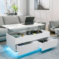 a white coffee table with two drawers underneath it