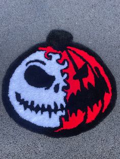 a close up of a patch on the ground with a skull and flame design in it