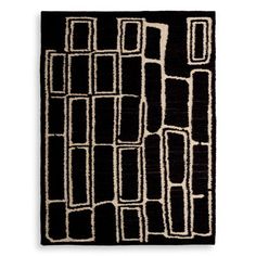 a black and white rug with square shapes on the side, in front of a white background