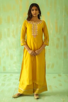 Ochre yellow kurta with mirrors and gota on the neckline and sleeve. Paired with a embroidered organza dupatta with embroidered pants.
Component: 3
Pattern: Embroidered
Type Of Work: Mirrors, Resham, Zari, Gota
Neckline: Boat
Sleeve Type: Long
Fabric: Chanderi, Organza, Lining: Cotton
Color: Yellow
Other Details: 
Organza dupatta
Embroidered pant
Occasion: Puja - Aza Fashions Yellow Straight Kurta Palazzo Set For Festivals, Gold Straight Kurta With Mirror Work, Gold Mirror Work Straight Kurta, Semi-stitched Yellow Kurta For Transitional Season, Yellow Chandbali Kurta For Diwali, Designer Yellow Salwar Kameez With Mirror Work, Festive Mustard Kurta With Resham Embroidery, Mustard Kurta With Dupatta For Festive Occasions, Festive Yellow Palazzo Set With Straight Kurta