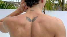 a man with a tattoo on his back