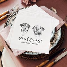 napkins with dogs drawn on them sitting on a table