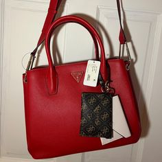 Cute Red Guess Bag! Has A Long Shoulder Strap And Many Compartments! Never Worn, Tags Attached. Pretty Red Color And Little Wallet Attachments! Open To Offers! Guess Red Bag, Trendy Red Bag With Branded Hardware, Trendy Red Bags With Branded Hardware, Trendy Red Shoulder Bag With Branded Hardware, Red Satchel With Top Handle And Branded Hardware, Burgundy Bag With Branded Hardware, Red Bag With Removable Pouch, Red Satchel Bag With Branded Hardware, Red Satchel With Removable Pouch For Shopping