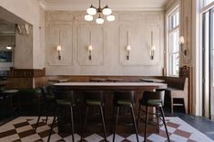 a kitchen with checkered flooring and white walls