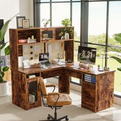 an office with a desk and chair in front of large windows