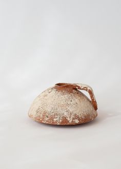 a piece of bread sitting on top of a white table