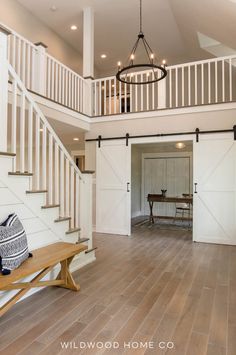 an open floor plan with white walls and wood floors