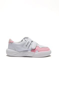 a white and pink sneaker with velcro straps on the side, in front of a white background