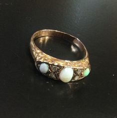 9ct rose gold ,hallmarked Chester 1921  Victorian style carved half hoop ring . Set with oval opals and old cut chip diamonds . It has a solid back ,so I can't see the back of the stones . Size S     USA 9  A nice vintage ring .  There is a faint hairline on the middle Opal. Priced accordingly. If you put your email in the notes , i will add it to the tracking details. Uk customers can use a mobile number. Opal And Diamond Ring, Gold Amethyst Ring, Creole Earrings, Gold Locket, Initial Ring, Cubic Zirconia Rings, Classic Gold, Gold Diamond Rings, Vintage Ring