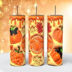 three candles decorated with pumpkins and leaves