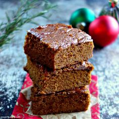 three brownies stacked on top of each other with christmas decorations in the back ground