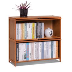 a book shelf with books and a potted plant on top