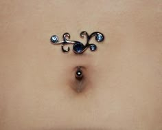 a woman's stomach with an upside down nose ring on top of her tummy