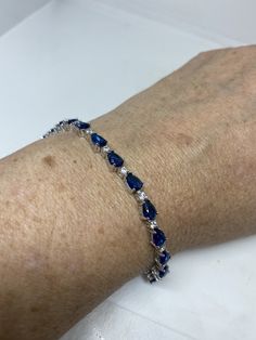 Vintage Cubic Zirconia Bracelet Clear blue Crystal Tennis 7.5 inches All jewelry is shipped free in the US in a nice gift box. Check out our over a THOUSAND great reviews Engraving is $4 per letter and is not always perfect depending on the piece. It can take a few days if the jeweler is busy. This is payable to Paypal Judithsltd@gmail.com Blue Cubic Zirconia Tennis Bracelet Fine Jewelry, Blue Sparkling Stones Bracelet For Formal Occasions, Blue Cubic Zirconia Bracelets For Formal Occasions, Blue Cubic Zirconia Bracelet With Sparkling Stones, Formal Blue Cubic Zirconia Bracelets, Blue Gemstone Bracelet In Cubic Zirconia, Blue Cubic Zirconia Crystal Bracelet, Blue Sapphire Diamond Bracelet Gift, Blue Sterling Silver Diamond Jubilee Bracelet