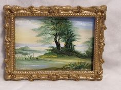 an oil painting on canvas of a tree by the water in a gold framed frame