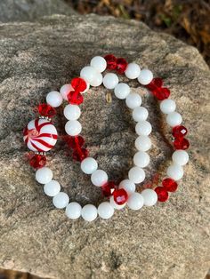 This bracelet is made with red faceted beads, white glass beads, daisy spacers and a candy cane bead. Note: Colors may vary depending on your monitor Shipping Info: All orders are shipped from Canada and they are sent through Canada Post.  If you would like expedited/faster shipping, it will cost more and you can reach out to me directly and I will give you pricing. Within Canada: Sent regular mail with no tracking and it can take 5-10 business days to arrive. United States: Sent with tracking a White Beaded Christmas Jewelry, White Christmas Jewelry With Colorful Beads, White Christmas Bracelets With Colorful Beads, Christmas White Bracelets With Colorful Beads, White Bracelets With Colorful Beads For Christmas, White Faceted Crystal Bracelet, White Crystal Bracelet With Faceted Beads, White Faceted Beads Crystal Bracelet, White Crystal Bracelet With Faceted Beads For Gift