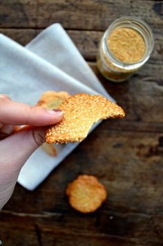 a person holding a piece of bread in their left hand and peanut butter on the other