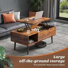 a living room with couch, coffee table and laptop on top of it in front of a large window