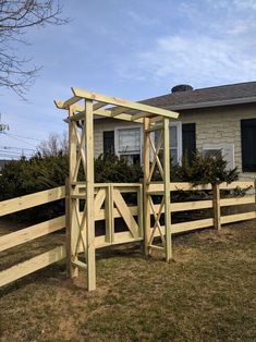 a wooden gate in front of a house