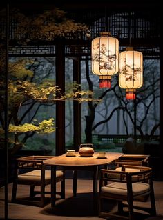 a table with chairs and two lamps hanging from it's ceiling in front of trees