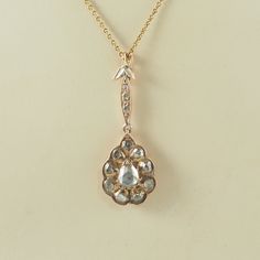 A very beautiful antique Victorian 14K rose gold and rose cut diamond pendant with clip fastening. The teardrop shaped pendant with a large teardrop shaped rose cut diamond, circa 0.5-0.7 carat, 6mm x 5mm, in a bezel and prong setting, with a surround of nine circular rose cut diamonds, each circa 0.05 carat, 3mm in diameter, in bezel settings. The diamonds in a closed back setting and foiled to enhance the brilliance. With a swagged pierced gallery. On a marquise shaped drop with three very fla Rose Cut Diamond Pendant, Rose Cut Diamond, Antique Victorian, Rose Cut, Diamond Pendant, Prong Setting, Or Rose, Antique Jewelry, Favorite Jewelry