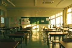 an empty classroom with desks and chairs