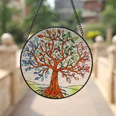 a stained glass tree hanging from a chain