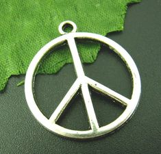 These adorable pendant style charms are made from zinc alloy metal and are lead and nickel free. They're perfect for crafting necklaces, bracelets, earrings, bookmarks, key chains and more! ♥ Antique Silver Tone Peace Sign Charms ♥ Material: Zinc Alloy Metal ♥ Size: 24mm ♥ Includes: 6 pieces We ship on the next business day from North Carolina via USPS. Tracking is included with all orders. Get free shipping on orders over $35! Don't forget to favorite us too, we add items daily. Thank you... cr Nickel-free Silver Novelty Charms, Nickel-free Round Metal Pendant Charm, Nickel-free Metal Round Pendant Charms, Nickel Free Round Metal Pendant Charms, Nickel-free Round Metal Charms, Nickel Free Round Metal Charms, Tiny Bird, Bird Charm, Small Earrings