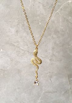 This listing is for one Serpent Pendant Necklace with a pear shaped cubic zirconia The snake pendant and chain are 18kt plated gold. Gold Snake Necklace, Pendant Minimalist, Snake Pendant, Snake Necklace, Gold Jewelry Necklace, Gold Snake, Jewelry Necklace, Minimalist Jewelry, Necklace Gold