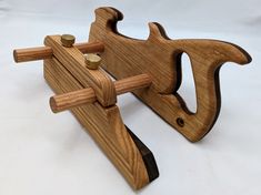 a wooden toy that is sitting on top of a white surface with two pegs attached to it