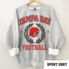 a tampa bay football sweatshirt hanging on a hanger