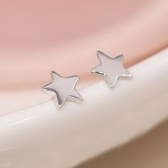 A pair of minimalistic sterling silver star stud earrings with a polished finish make the perfect gift for wearers of all ages. Not to be found anywhere on the high street, our beautiful star studs are crafted from the finest sterling silver. With a lovely polished finish, these lovely twinkling star earrings feature a classic butterfly and post fastening and are suitable for almost any age. Make your earrings even more special by choosing one of our beautiful card inserts that are set inside th Teen Earrings, Second Hole Earrings, Constellation Earrings, Star Stud Earrings, Simple Stud Earrings, Tiny Star, Geometric Star, Star Earrings Stud, Celestial Jewelry