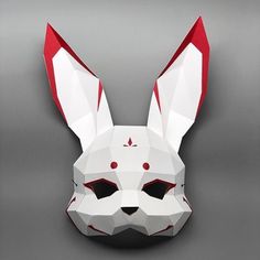 an origami rabbit mask is shown on a gray background, with red and white details