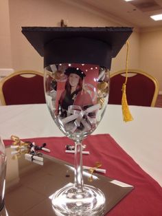 a graduation cap on top of a wine glass