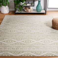 a living room area with a rug, vases and other items on the floor