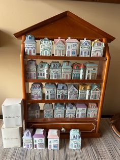 a wooden shelf filled with lots of small houses