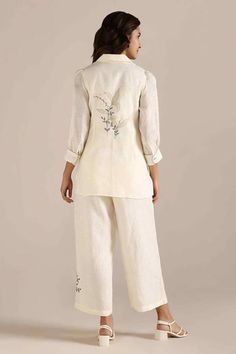 Off-white tie-up top with thread applique embroidery in floral pattern. Paired with flared pant. - Aza Fashions White Relaxed Fit Sets For Spring, Embroidered Cream Sets For Spring, Beige Floral Embroidered Pants For Spring, White Long Sleeve Pant Set For Summer, White Pant Set For Spring Wedding, White Spring Wedding Pant Set, White Linen Sets For Spring, Summer Beige Pant Set, White Floral Embroidered Wide-leg Bottoms